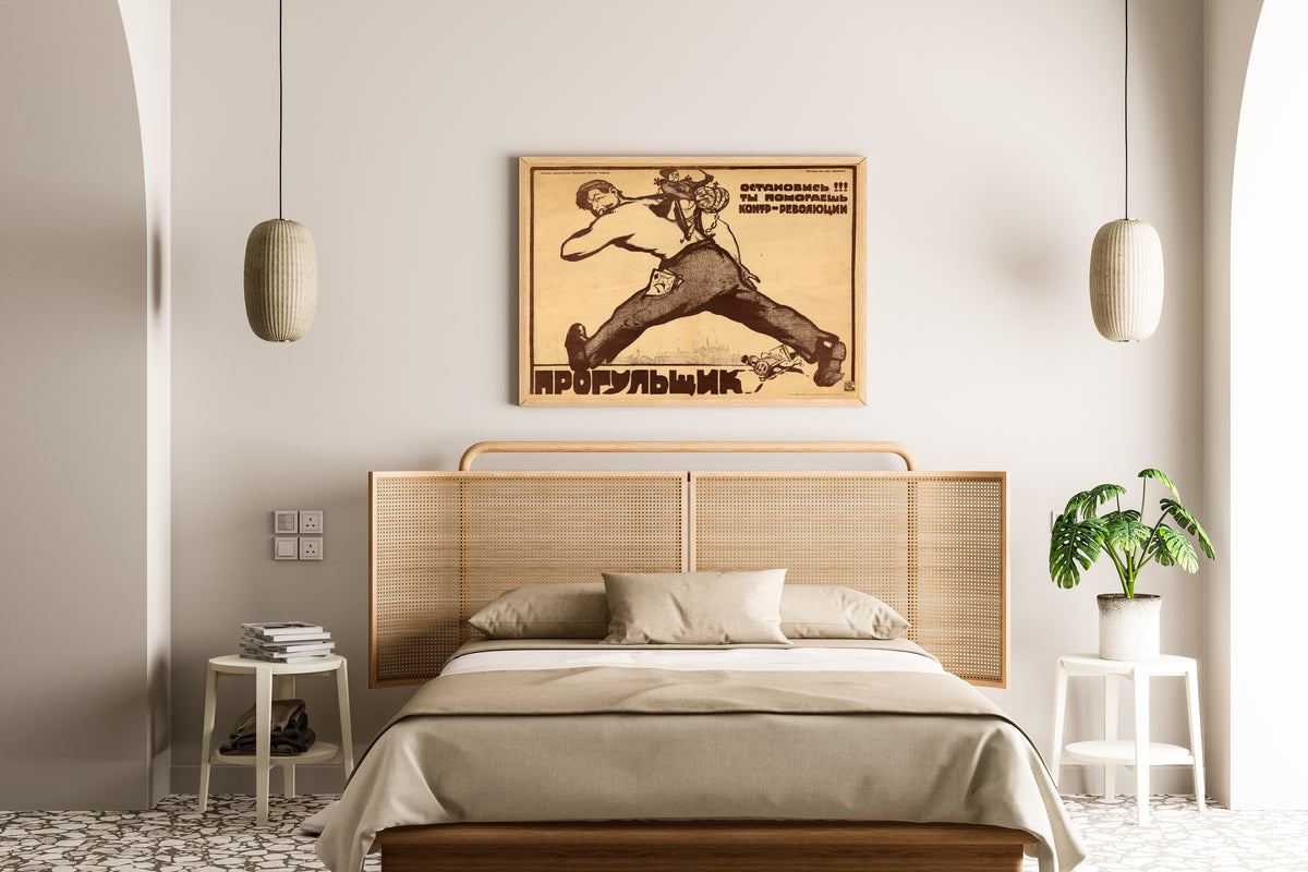 Framed art print of Absentee, Stop! You Are Helping the Counter-revolution! by Vasily Kostyanitsyn, above a cane-headboard bed