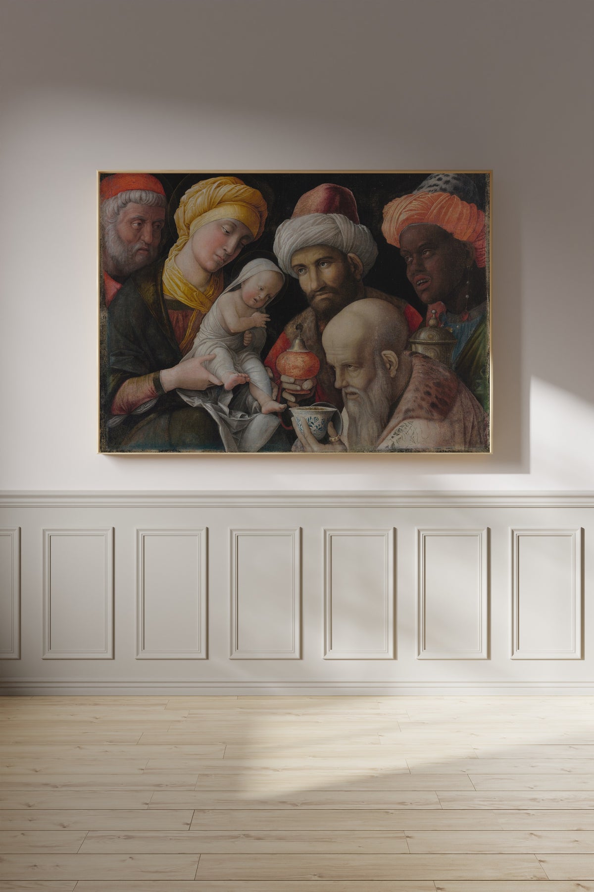 Framed art print of Adoration of the Magi by Andrea Mantegna, on a panelled wall in afternoon light