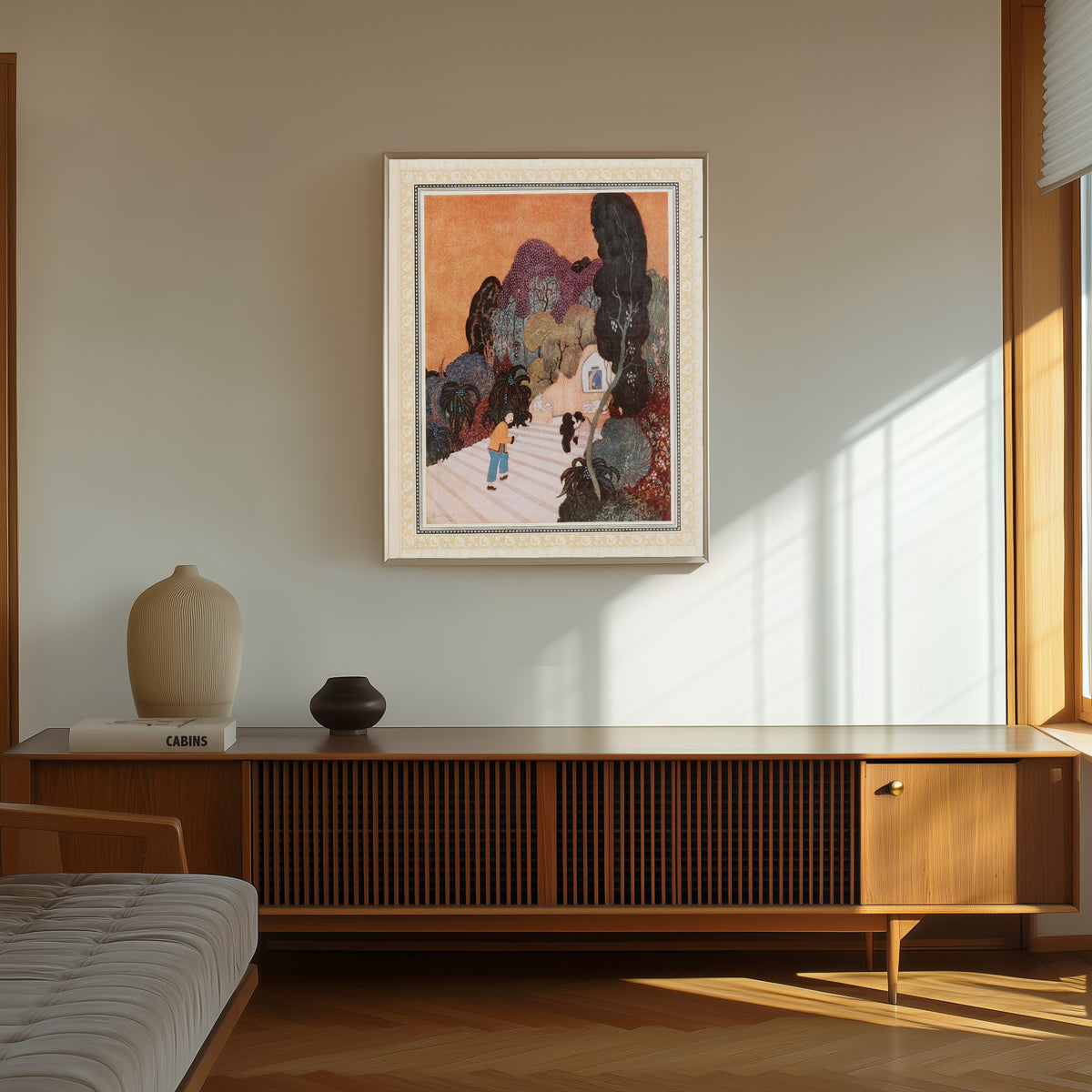Framed art print of Aladdin finds the Magic Lamp by Edmund Dulac, in a thin light frame on a sunlit wall above a wooden sideboard