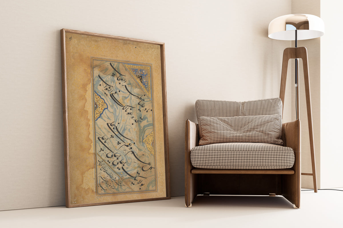 Framed art print of Album Leaf with Shi'a Invocation, leaning against a wall beside an armchair and a floor lamp
