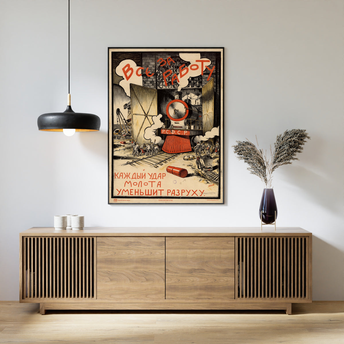 Framed art print of All to Work: Every Blow of the Hammer Lessens the Ruin by Sergey Ivanov, above a slatted wood sideboard