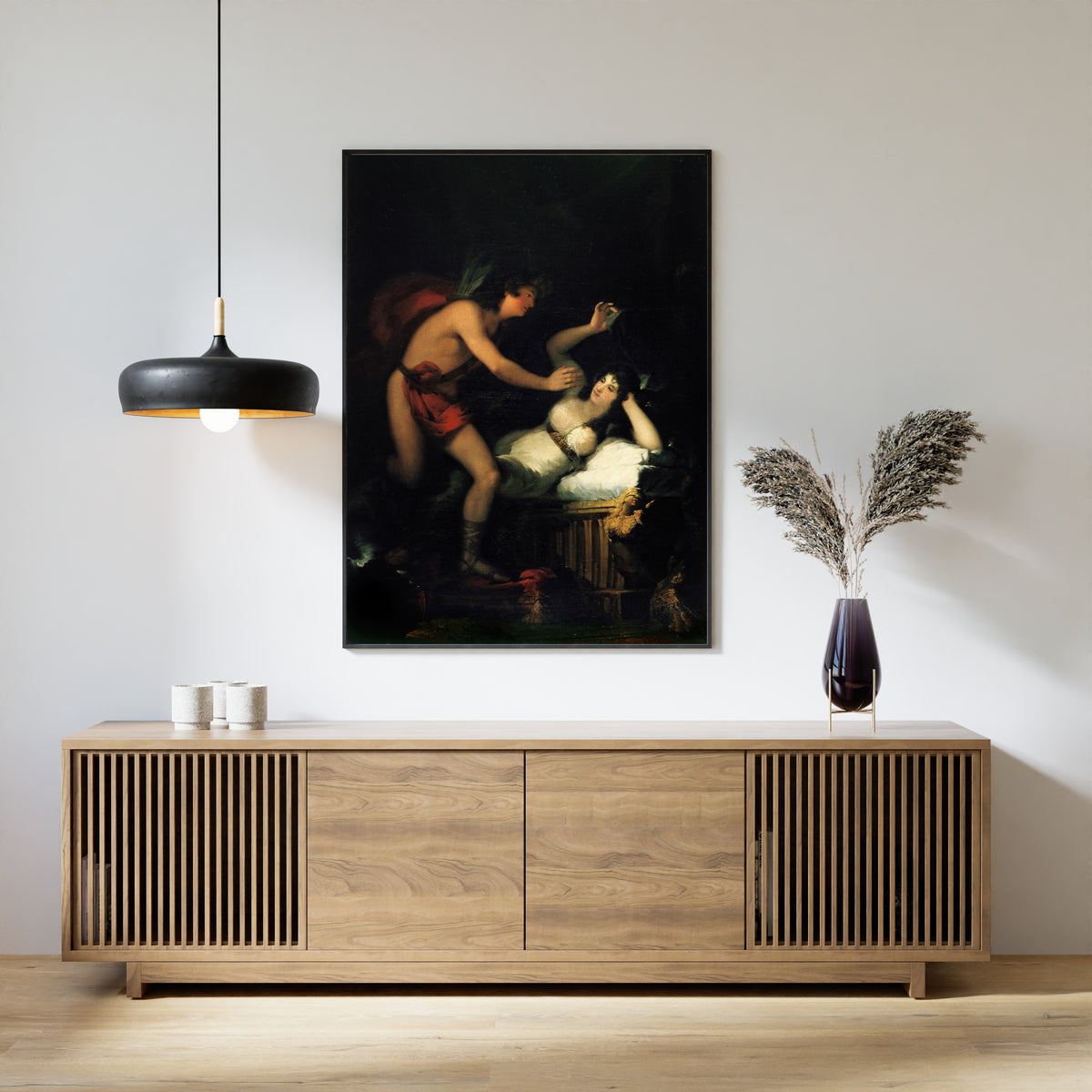 Framed art print of Allegory of Love, Cupid and Psyche by Francisco de Goya, above a slatted wood sideboard