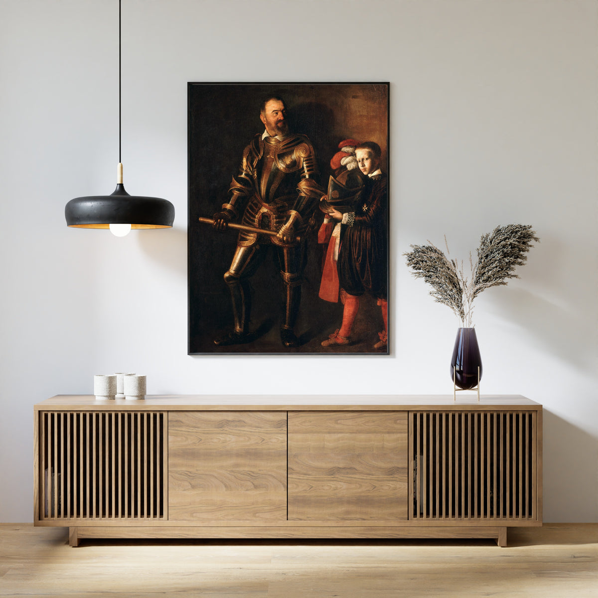 Framed art print of Alof de Wignacourt by Caravaggio, above a slatted wood sideboard