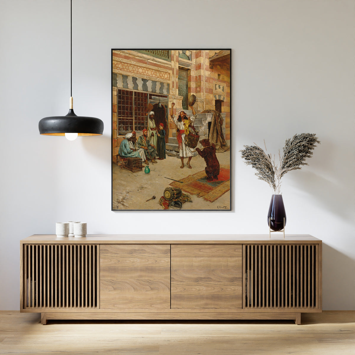 Framed art print of An Afternoon Show by Rudolf Ernst, above a slatted wood sideboard