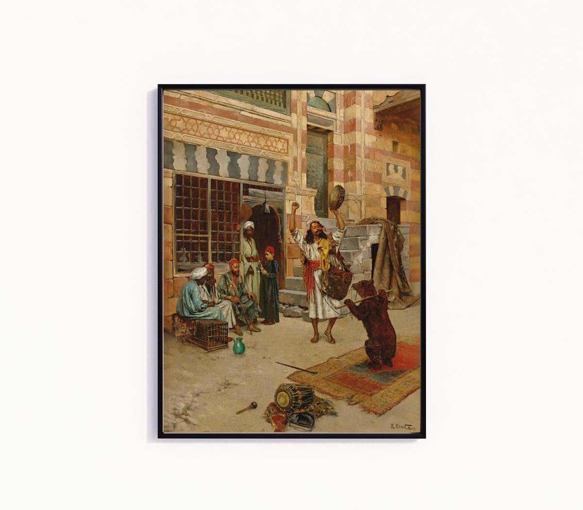 Framed art print of An Afternoon Show by Rudolf Ernst, in a slim black frame on a plain white wall