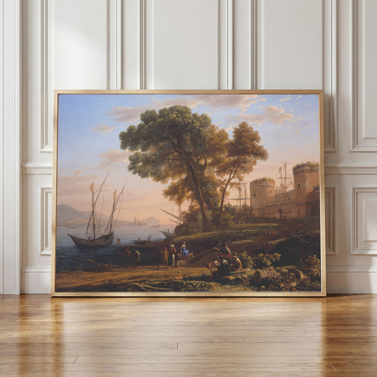 Framed art print of An Artist Studying from Nature by Claude Lorrain, in a light wood frame leaning against a panelled white wall