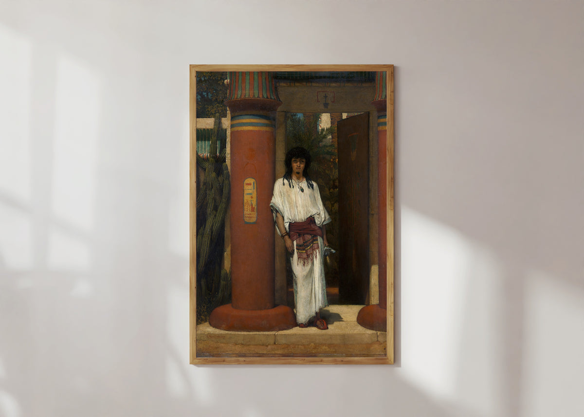 Framed art print of An Egyptian in a Doorway by Lawrence Alma-Tadema, in a light wood frame on a sunlit white wall