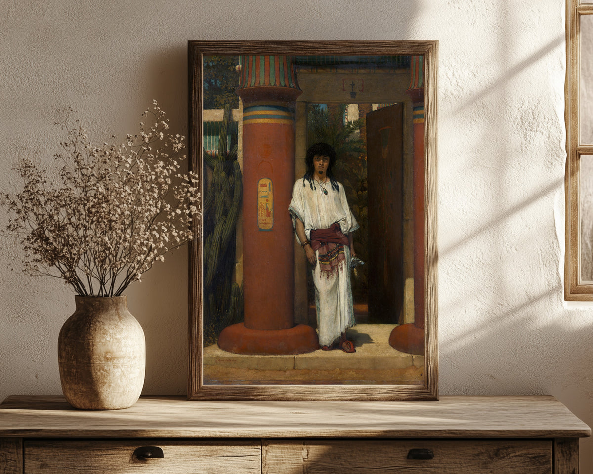 Framed art print of An Egyptian in a Doorway by Lawrence Alma-Tadema, in a dark wood frame leaning on a rustic console beside dried flowers