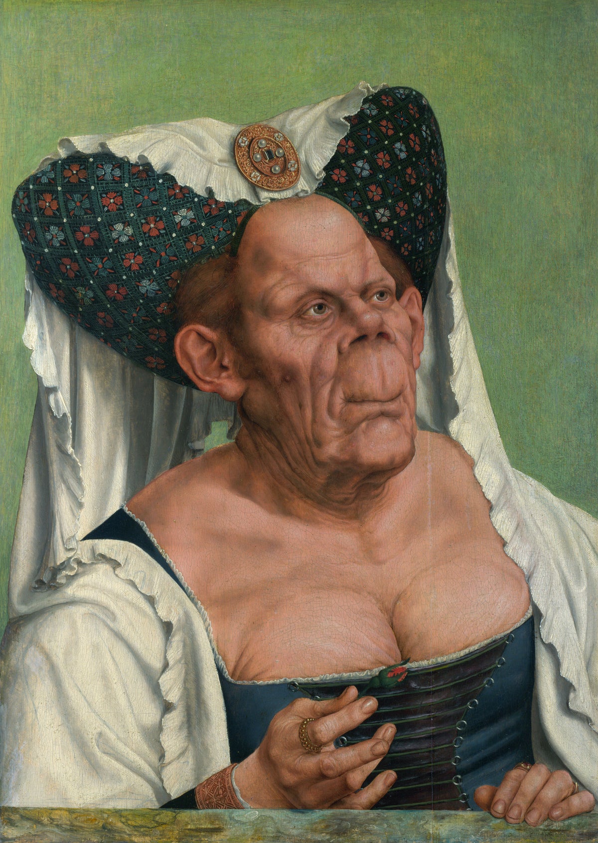 An Old Woman (The Ugly Duchess) by Quinten Massys — An old woman in a horned headdress with a red rosebud at her bodice