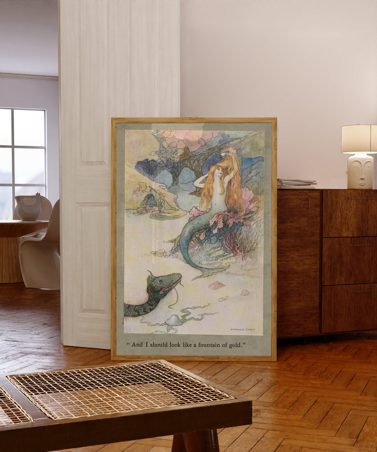 Framed art print of And I should look like a fountain of gold. by Warwick Goble, in a light wood frame leaning in a warm room with a parquet floor