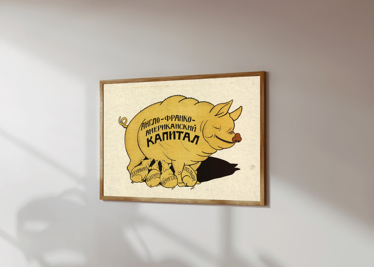 Framed art print of Anglo-Franco-American capital, in a light wood frame on a sunlit white wall, seen at a slight angle