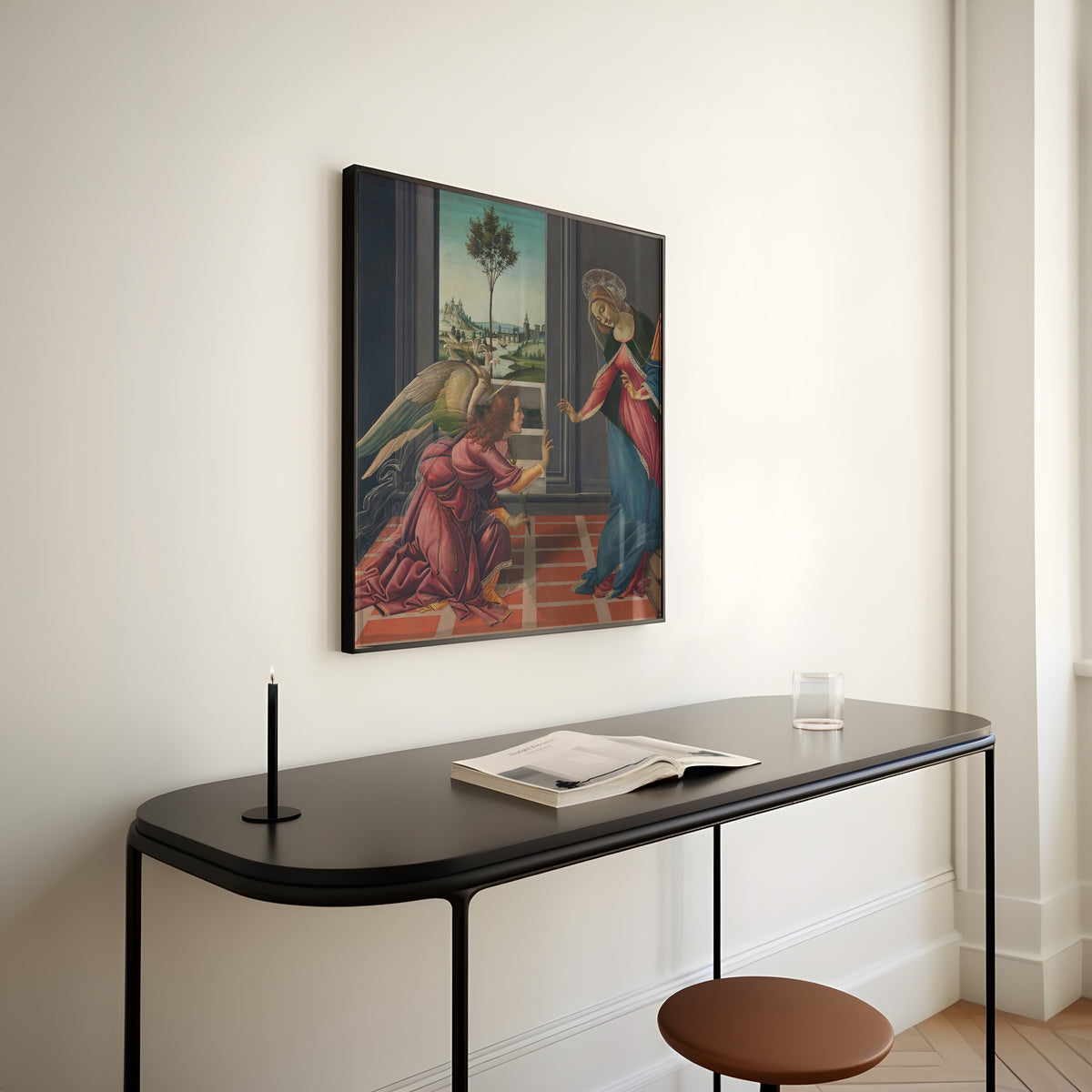 Framed art print of Annunciation by Sandro Botticelli, above a slim black console table
