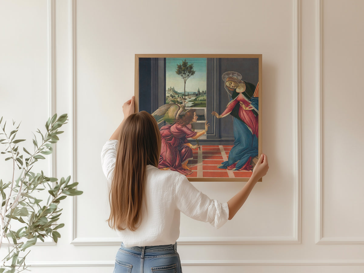 Framed art print of Annunciation by Sandro Botticelli, hung on a panelled wall