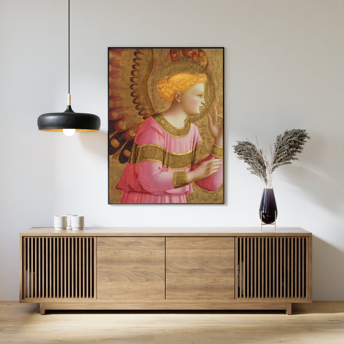 Framed art print of Annunciatory Angel by Fra Angelico, above a slatted wood sideboard