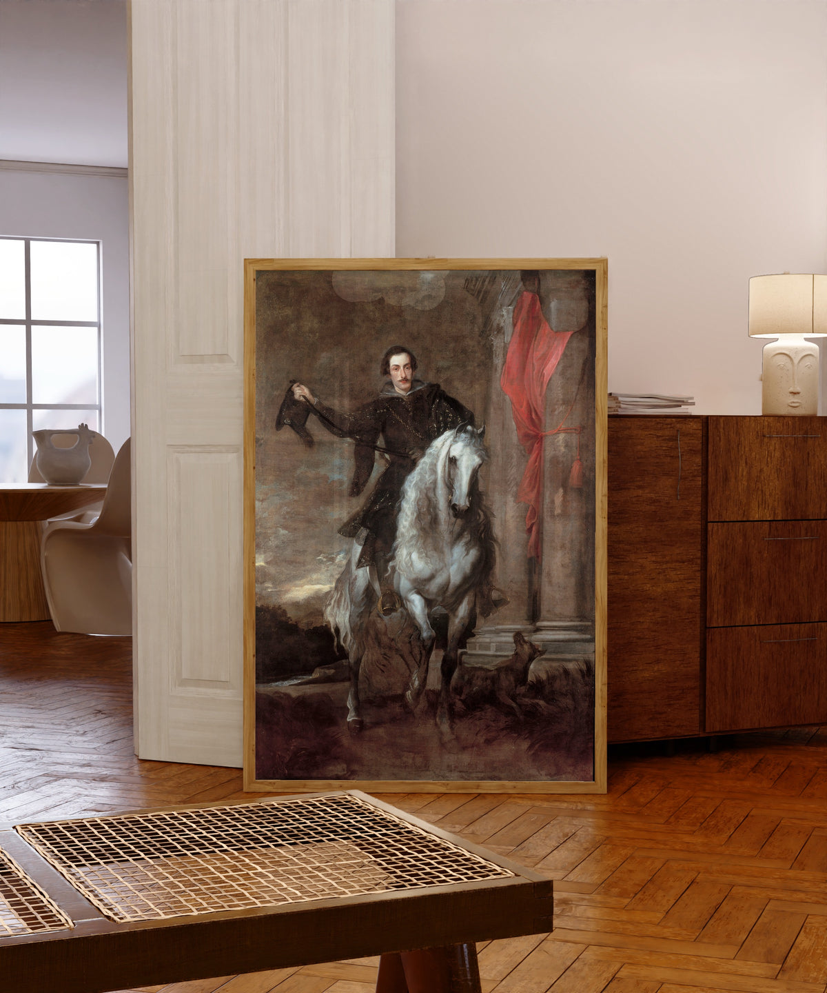Framed art print of Anton Giulio Brignole-Sale on Horseback by Anthony van Dyck, in a light wood frame leaning in a warm room with a parquet floor