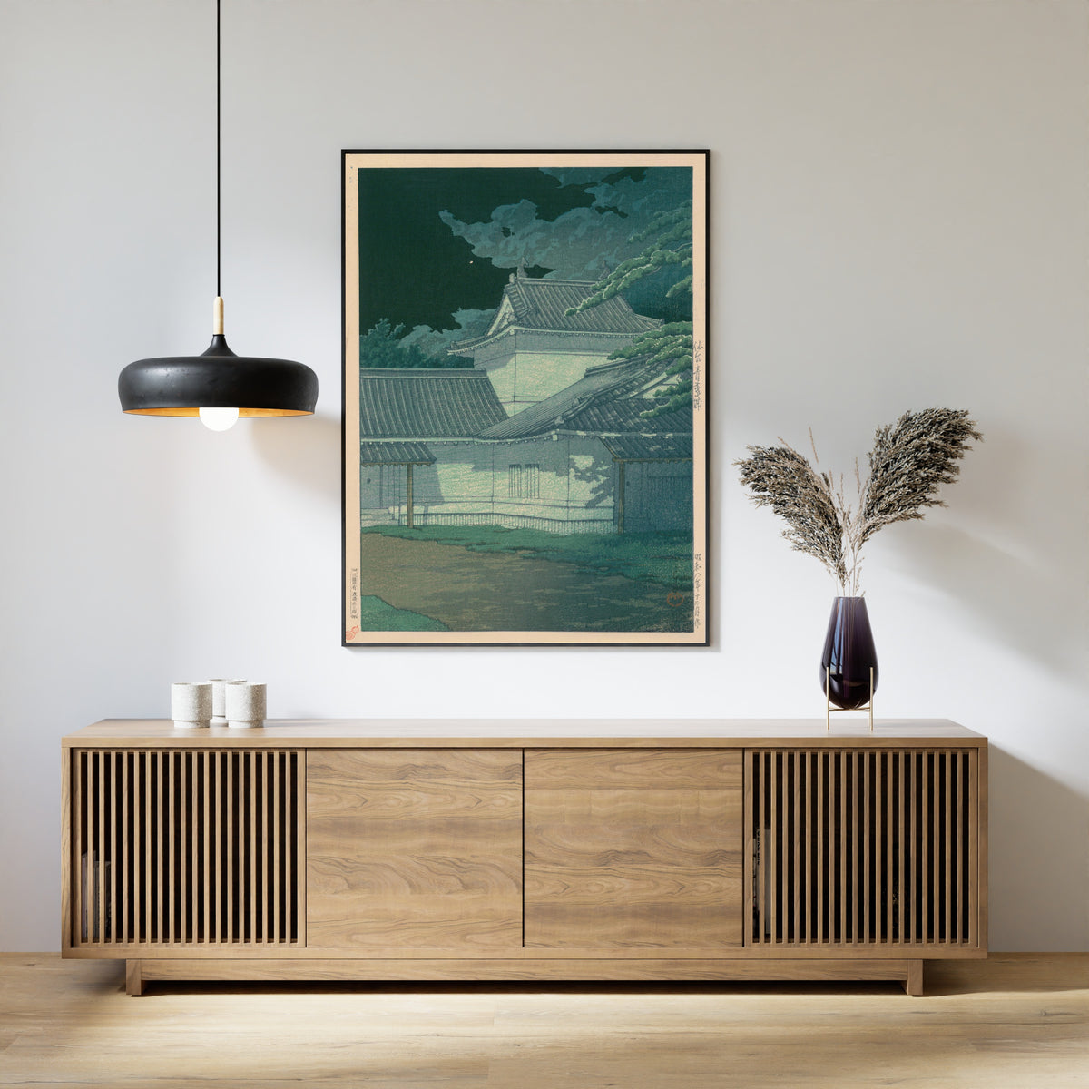Framed art print of Aoba Castle, Sendai by Kawase Hasui, above a slatted wood sideboard