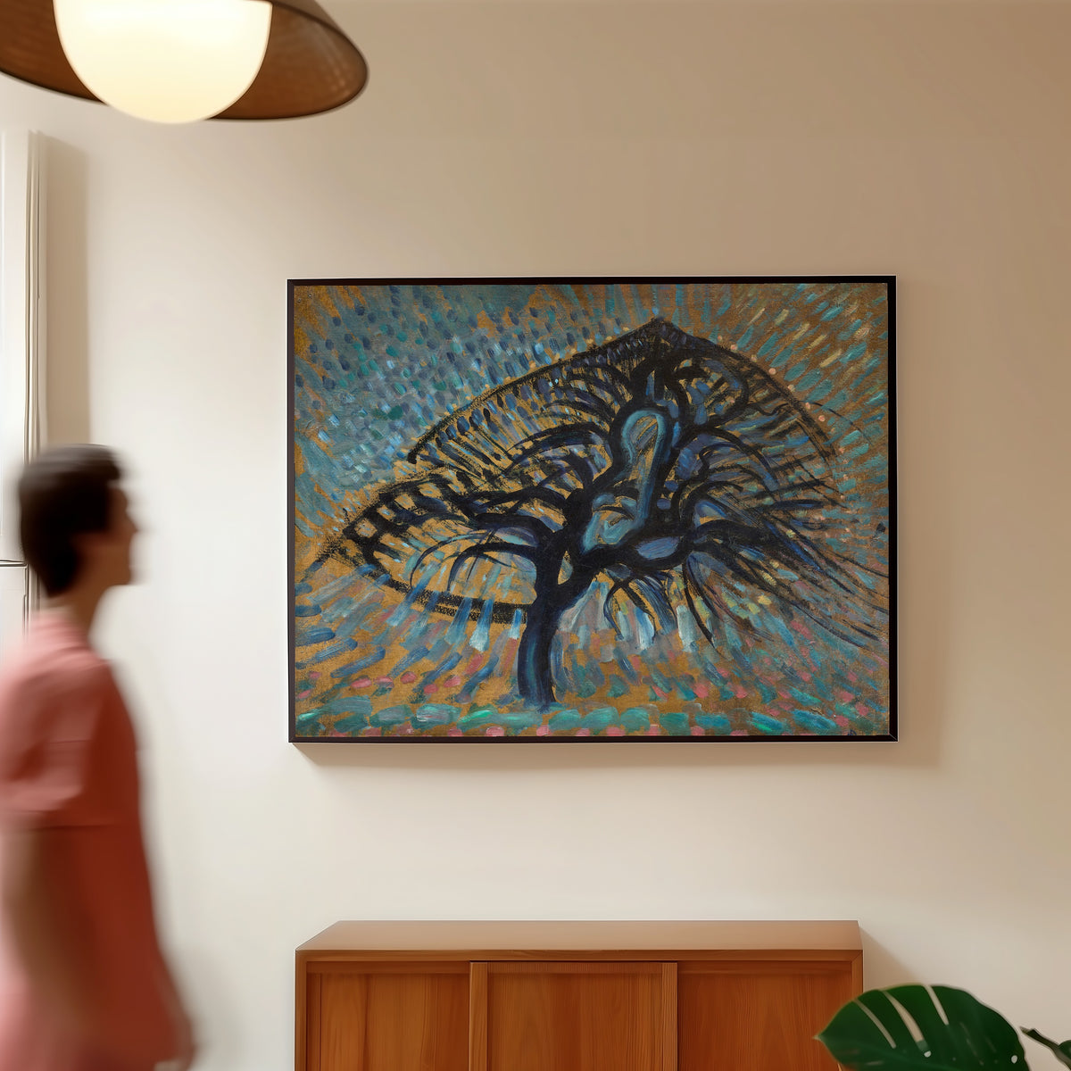 Framed art print of Apple Tree, Pointillist Version by Piet Mondrian, in a slim black frame on a warm wall in a sunlit room