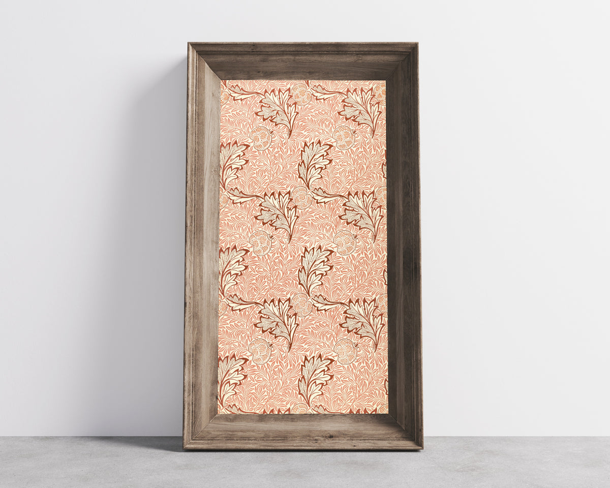 Framed art print of Apple by William Morris, in a wide wooden frame leaning against a concrete wall