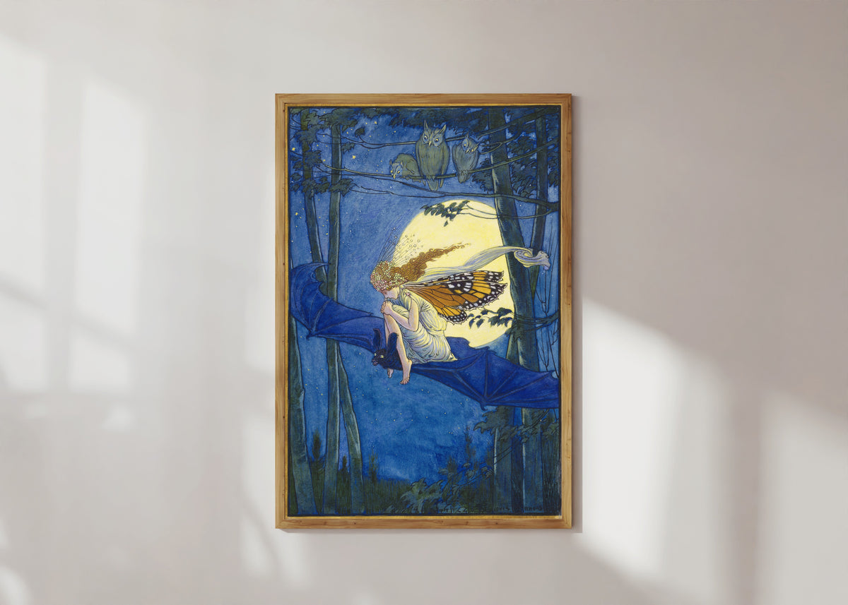 Framed art print of Ariel on a Bat's Back by Louis Rhead, in a light wood frame on a sunlit white wall