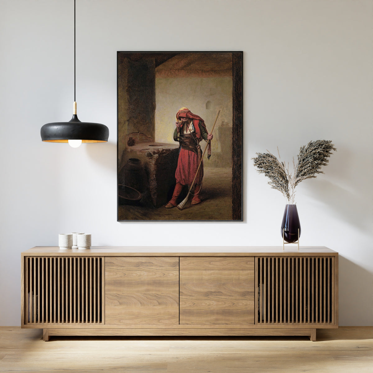 Framed art print of Arnaut Drinking by Jean-Léon Gérôme, above a slatted wood sideboard