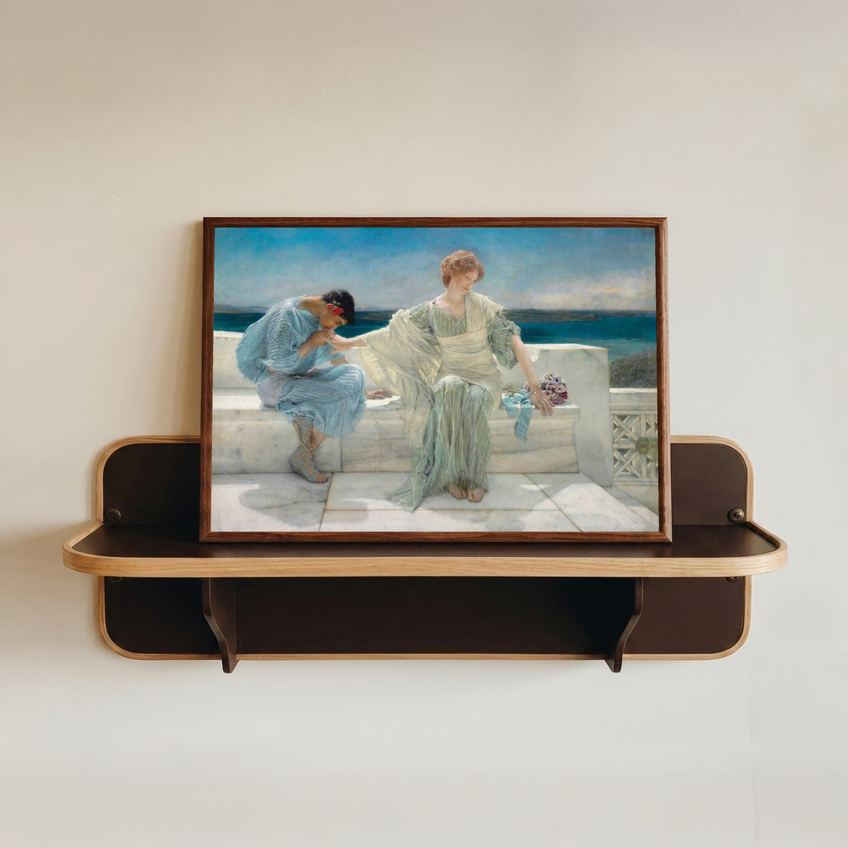 Framed art print of Ask Me No More by Lawrence Alma-Tadema, in a dark wood frame resting on a wall shelf