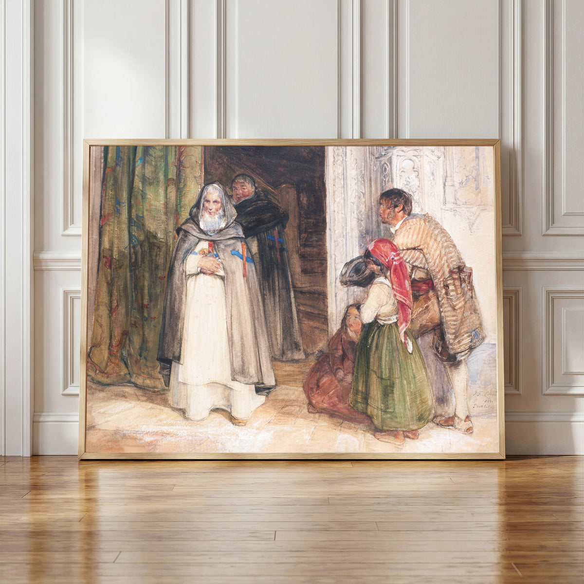 Framed art print of Asking for Alms by John Frederick Lewis, in a light wood frame leaning against a panelled white wall