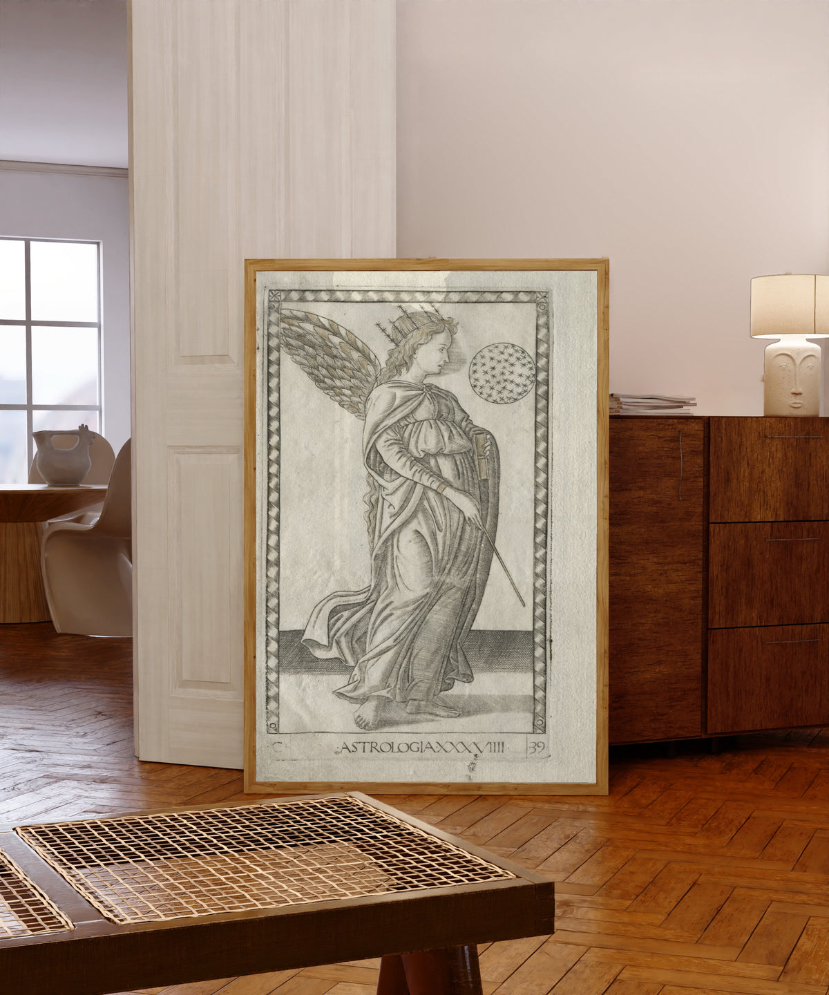 Framed art print of Astrology (from the Tarocchi, Series… by Master of the E-Series Tarocchi, in a light wood frame leaning in a warm room with a parquet floor