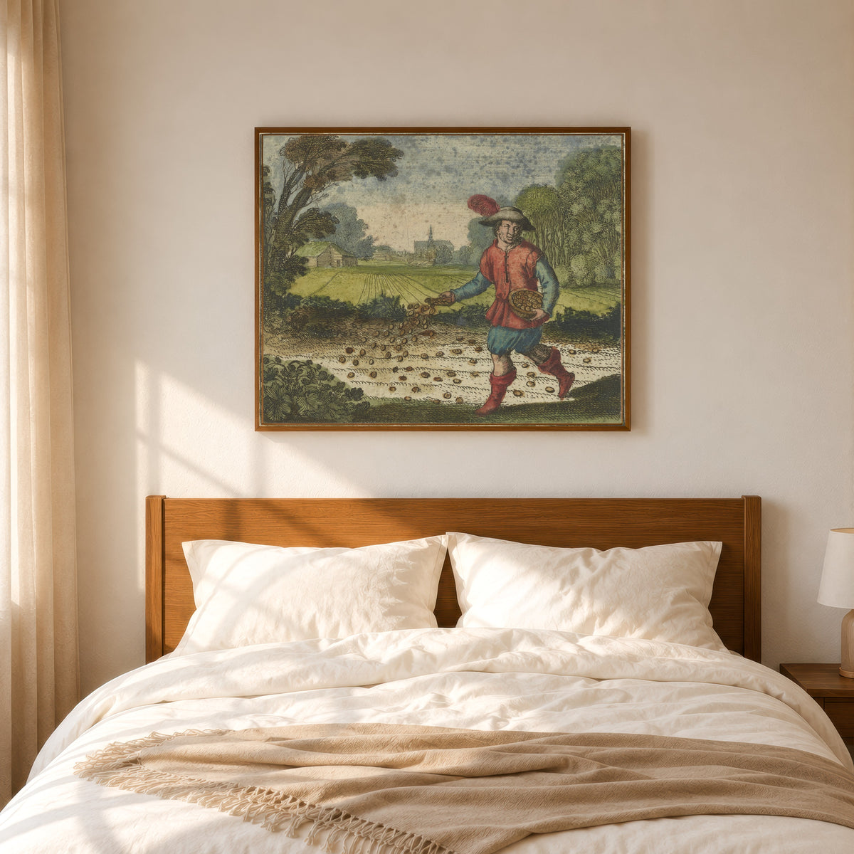 Framed art print of Atalanta Fugiens, Emblem 6: Sow Your Gold in the White Foliate Earth by Michael Maier, in a slim wood frame above a bed in a sunlit bedroom