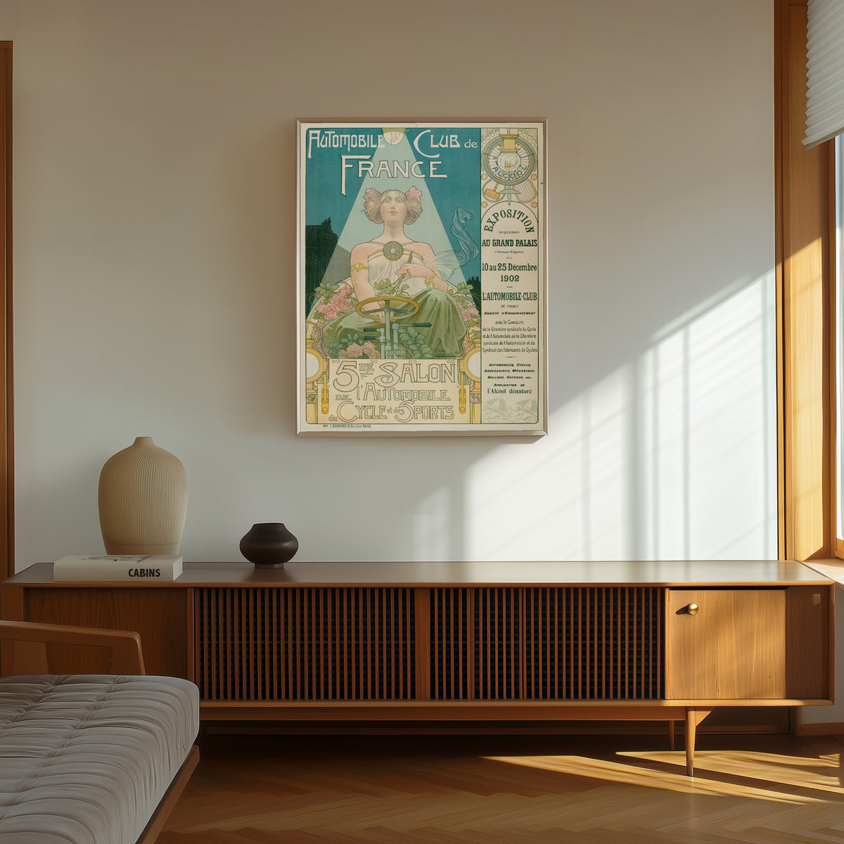 Framed art print of Automobile Club de France, 5me Salon de… by Henri Privat-Livemont, in a thin light frame on a sunlit wall above a wooden sideboard