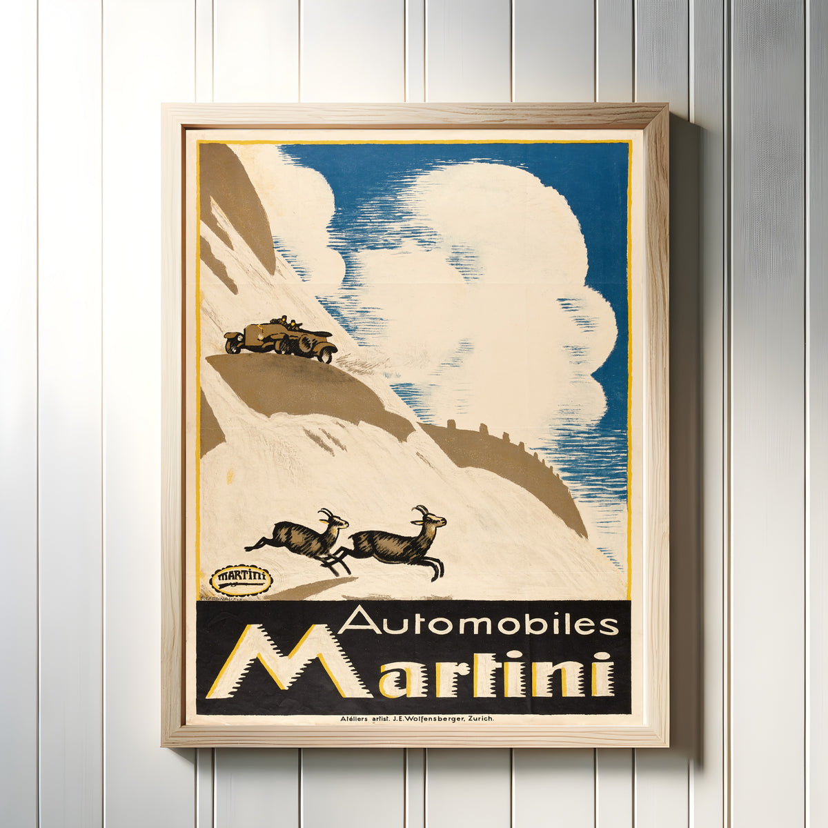 Framed art print of Automobiles Martini by Emil Cardinaux, in a light wood frame on a white panelled wall