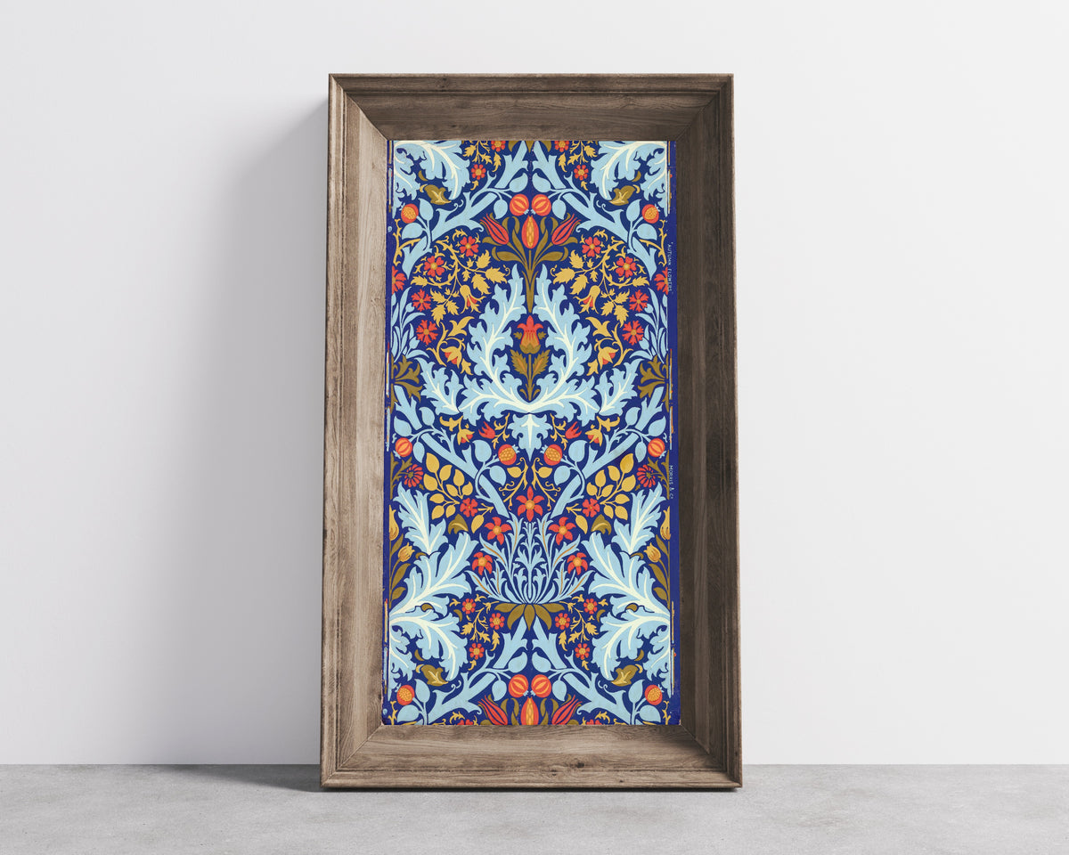 Framed art print of Autumn Flowers by William Morris, in a wide wooden frame leaning against a concrete wall