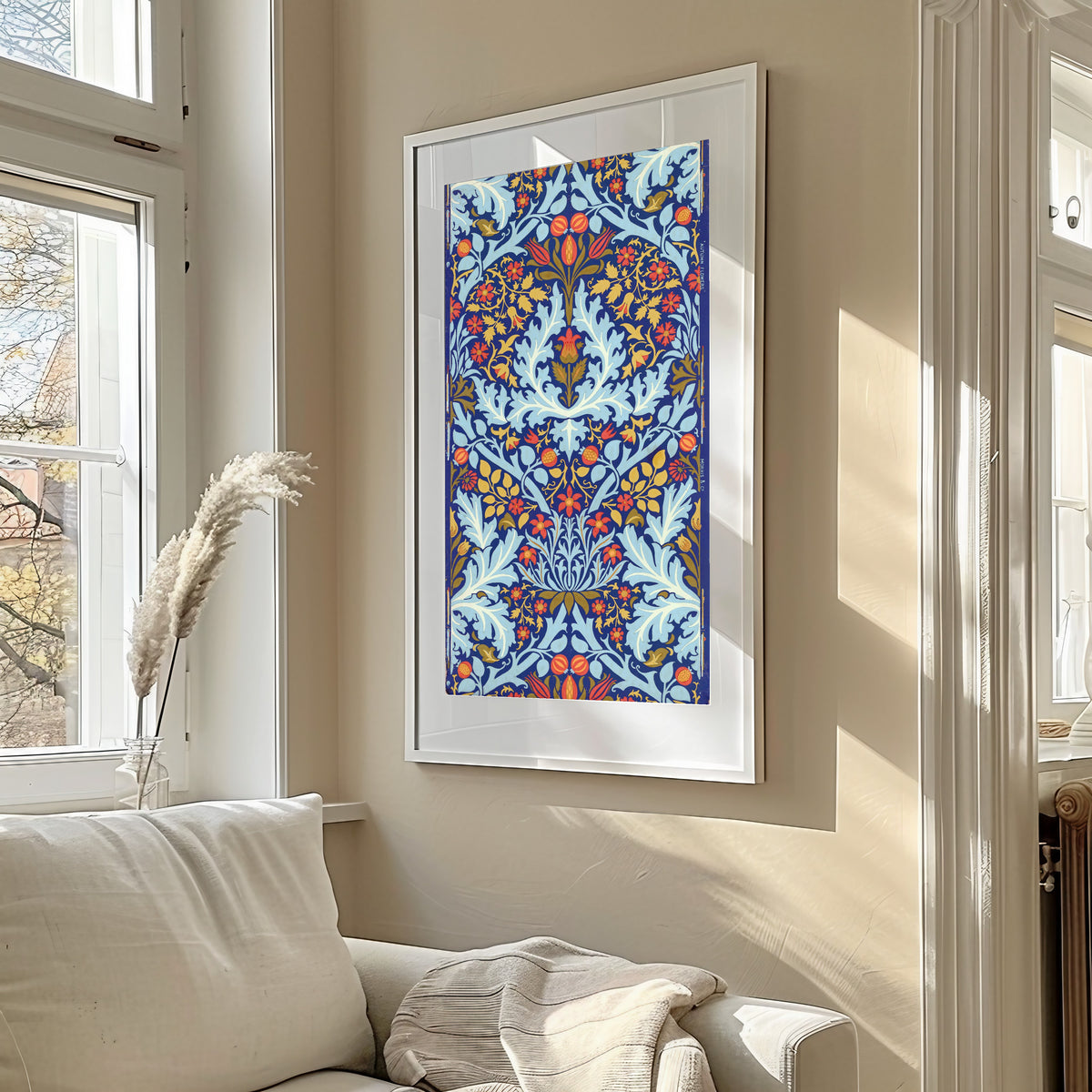 Framed art print of Autumn Flowers by William Morris, in a sunlit living room above a sofa