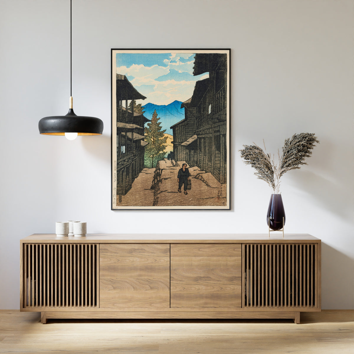 Framed art print of Autumn in Arayu, Shiobara by Kawase Hasui, above a slatted wood sideboard