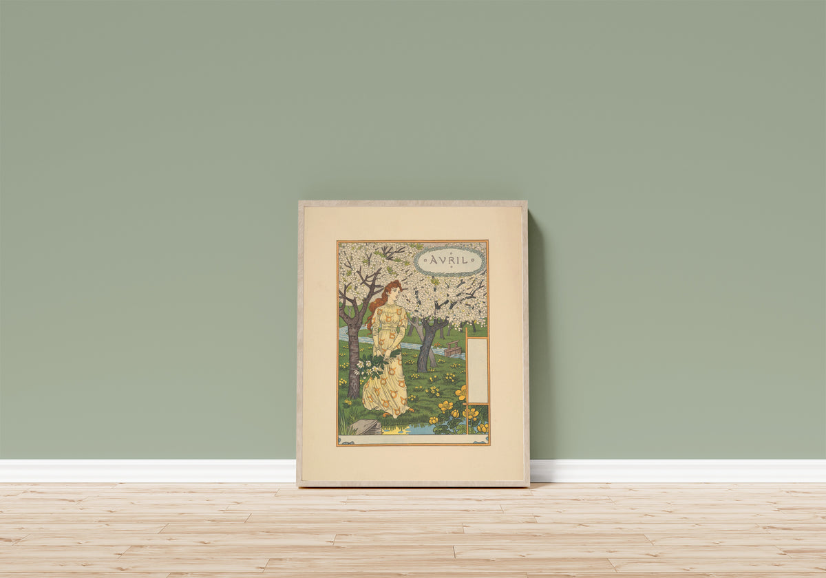 Framed art print of Avril by Eugène Grasset, in a light wood frame leaning on a sage green wall above a wooden floor