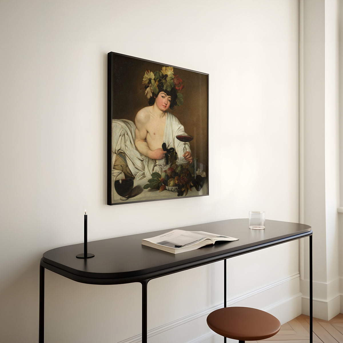 Framed art print of Bacchus by Caravaggio, above a slim black console table