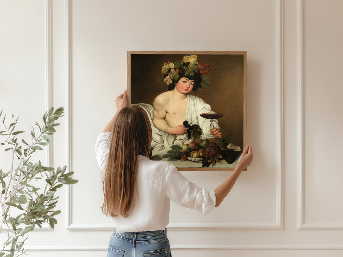 Framed art print of Bacchus by Caravaggio, hung on a panelled wall