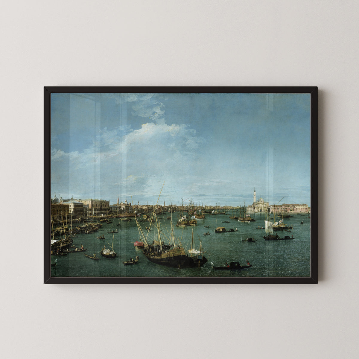 Framed art print of Bacino di San Marco, Venice by Canaletto, in a black frame on a pale wall