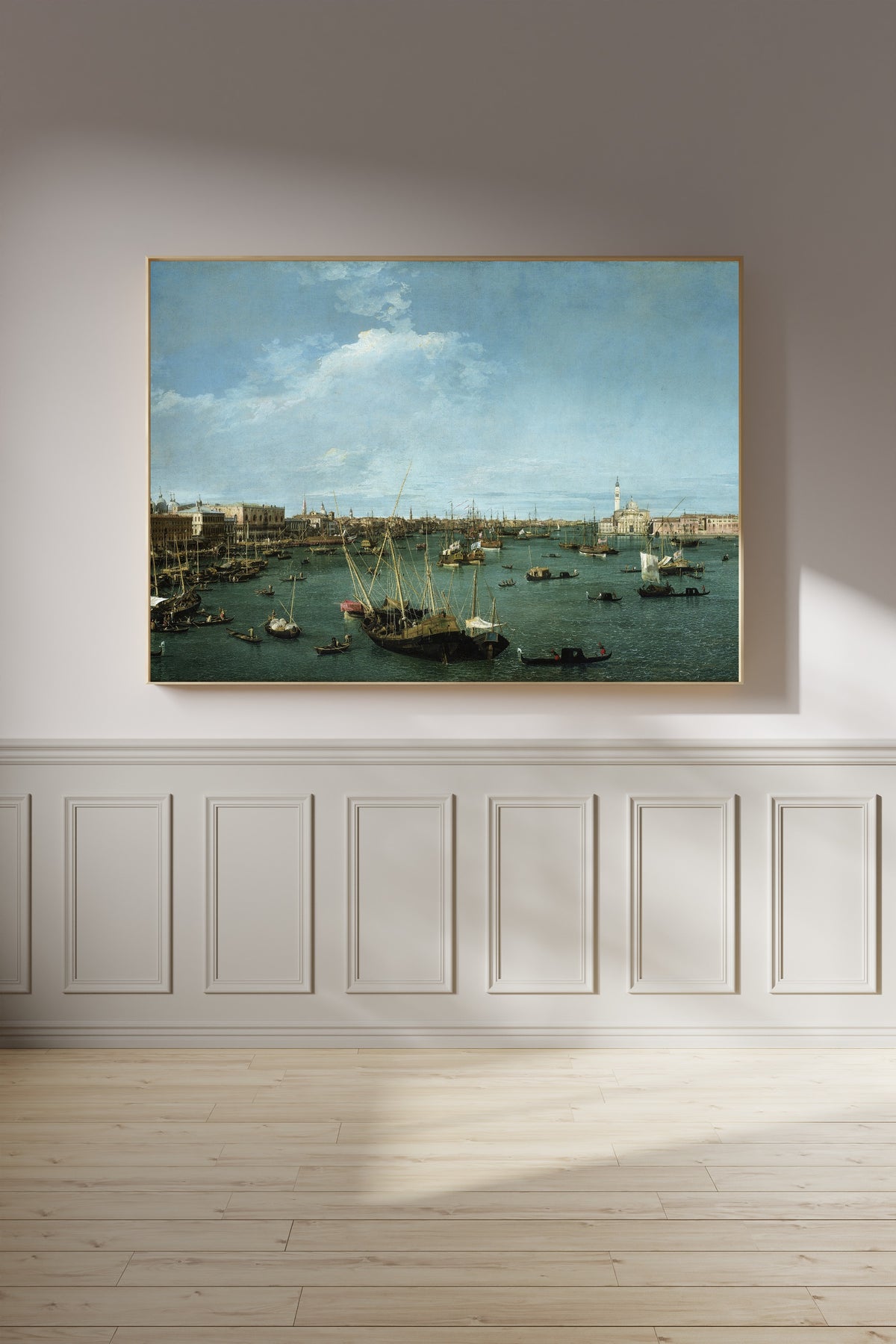 Framed art print of Bacino di San Marco, Venice by Canaletto, on a panelled wall in afternoon light