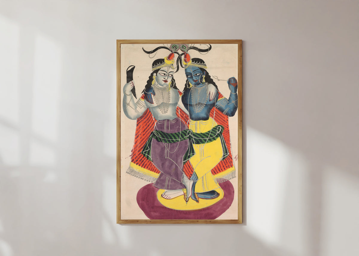 Framed art print of Balarama and Krishna by Kalighat painter, in a light wood frame on a sunlit white wall