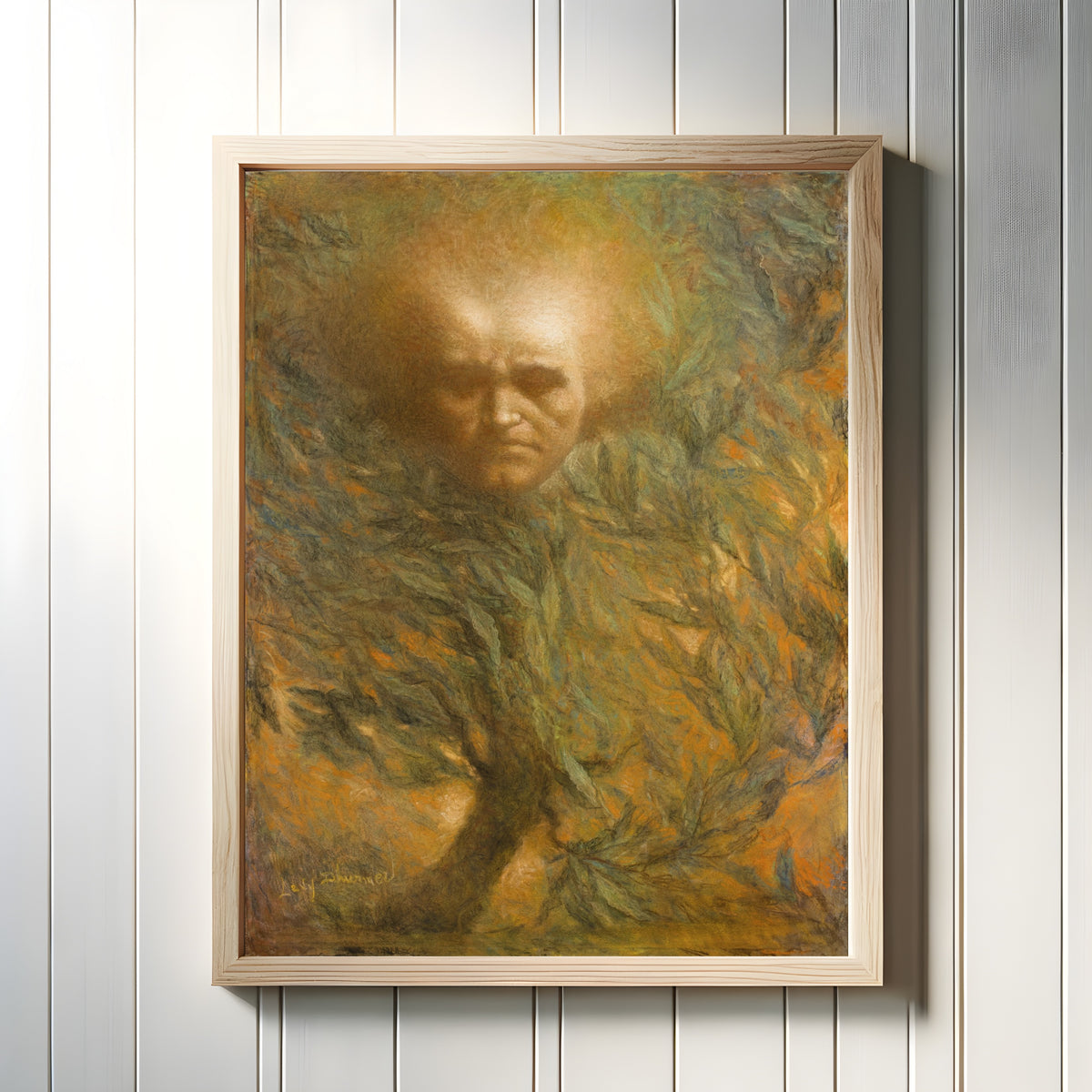 Framed art print of Beethoven Mask by Lucien Lévy-Dhurmer, in a light wood frame on a white panelled wall