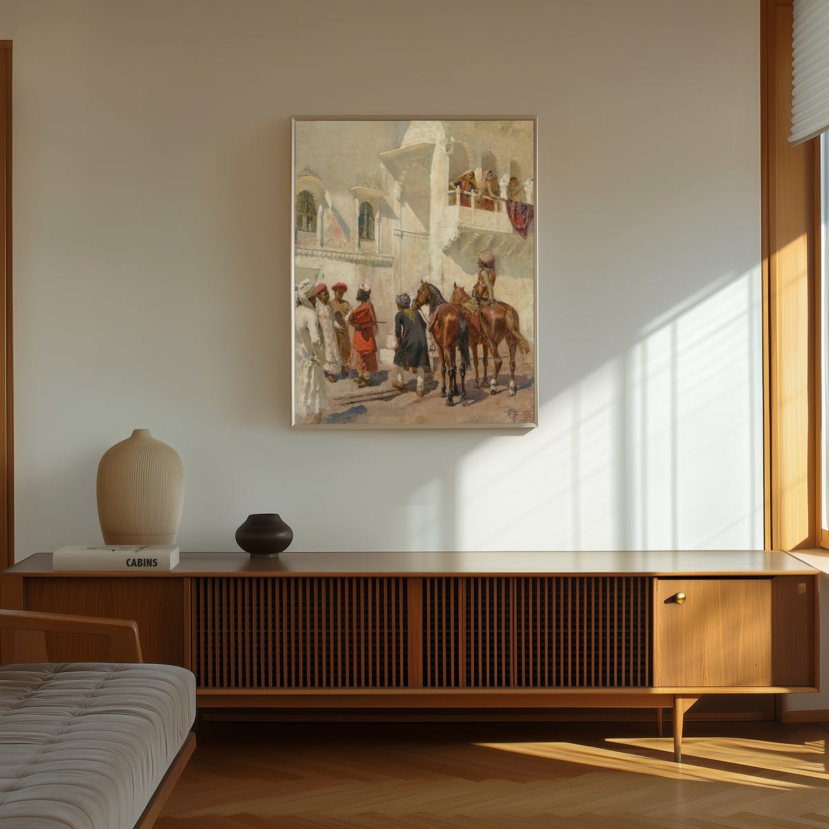 Framed art print of Before the Hunt by Edwin Lord Weeks, in a thin light frame on a sunlit wall above a wooden sideboard