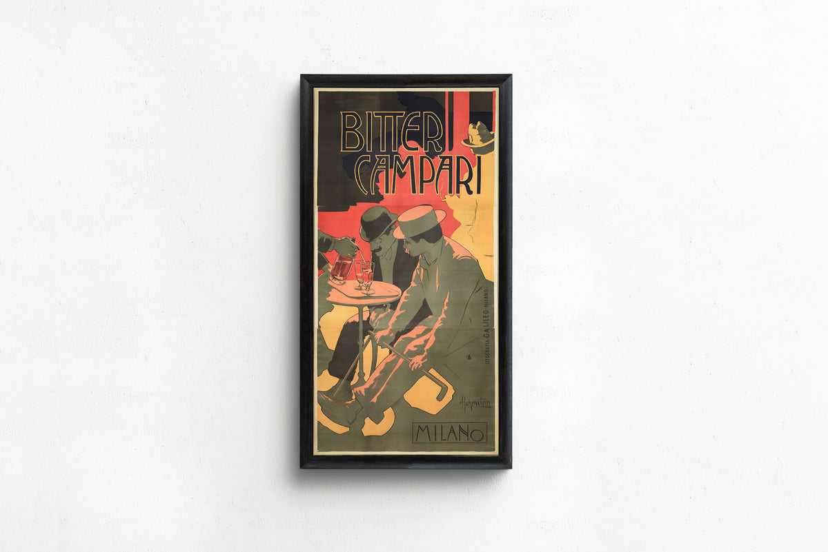 Framed art print of Bitter Campari by Adolfo Hohenstein, in a slim black frame on a plain white wall