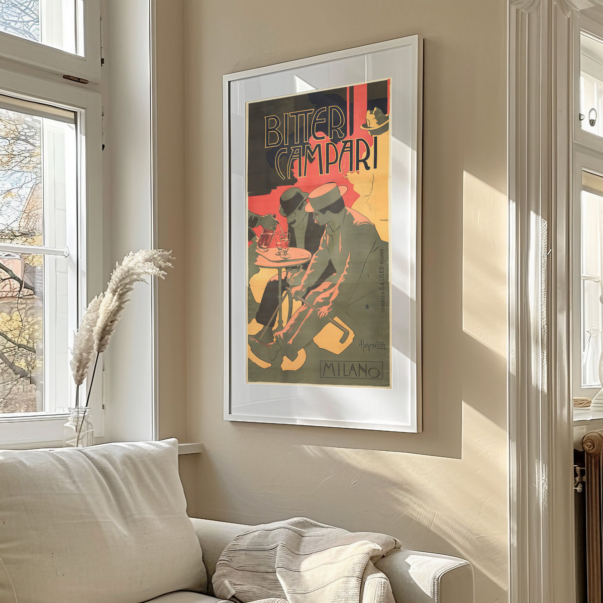 Framed art print of Bitter Campari by Adolfo Hohenstein, in a sunlit living room above a sofa