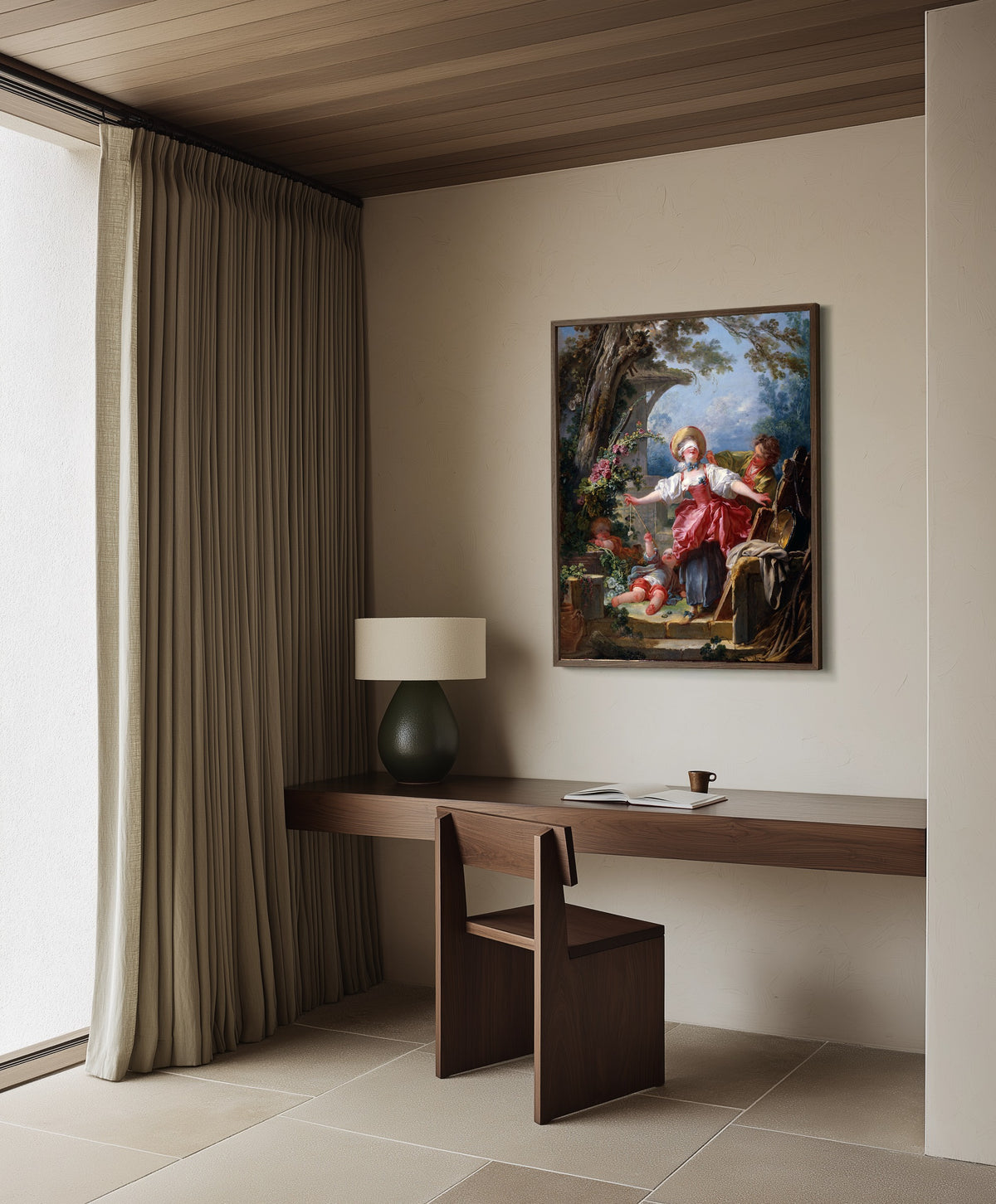 Framed art print of Blind-Man’s Buff by Jean-Honoré Fragonard, in a dark wood frame on a plaster wall above a walnut desk
