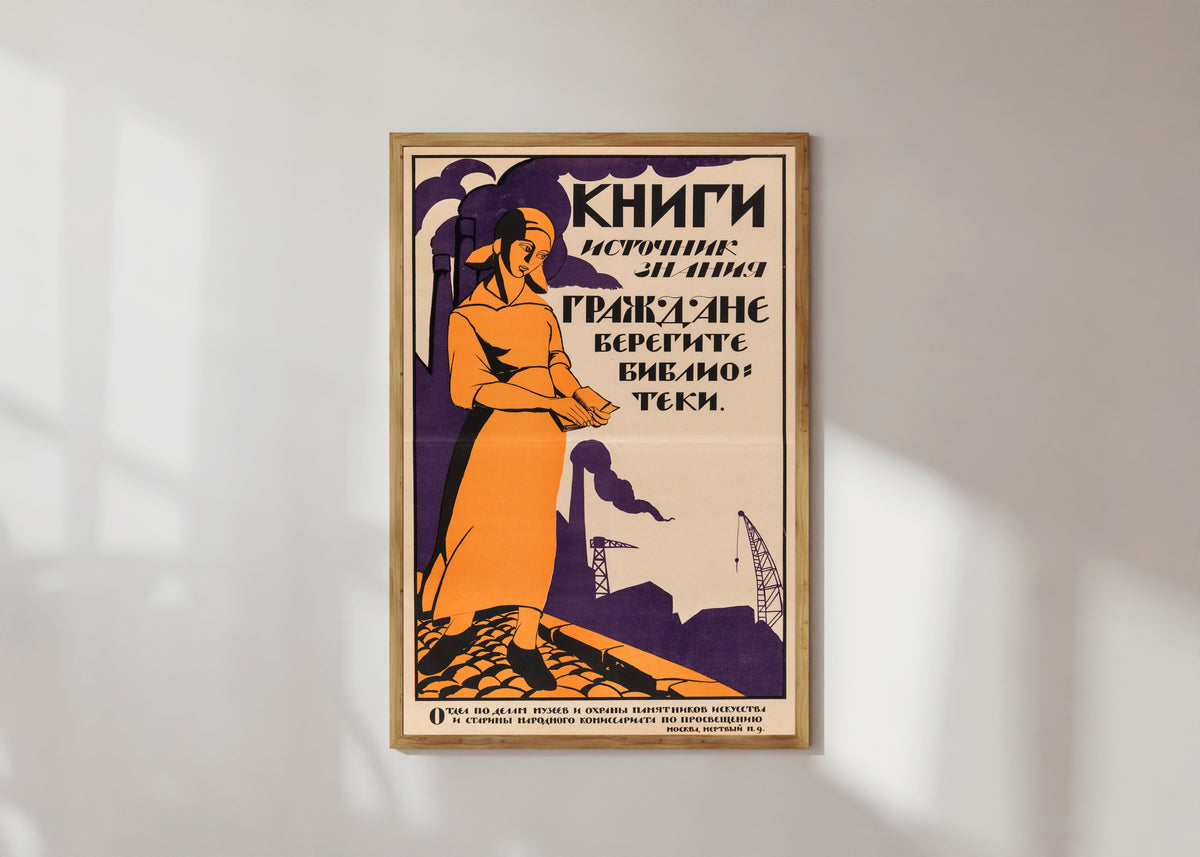 Framed art print of Books are the source of knowledge. Citizens, take care of the libraries by Nikolai Kupreyanov, in a light wood frame on a sunlit white wall