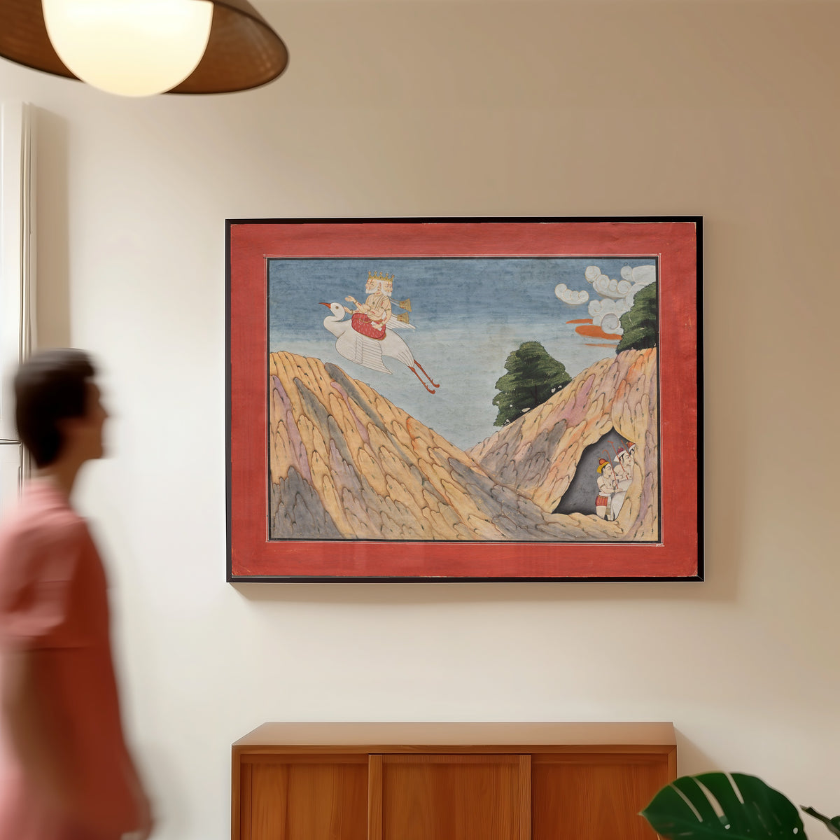 Framed art print of Brahma Hides the Cowherds and the Calves in the Cave by Basohli school, in a slim black frame on a warm wall in a sunlit room