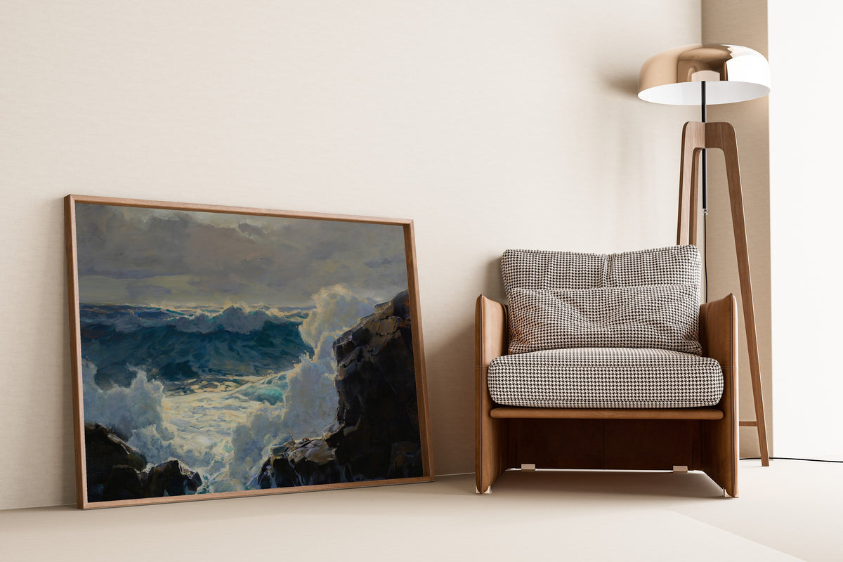Breaking Waves by Frederick Judd Waugh — framed and leaning against a wall beside an armchair and a floor lamp