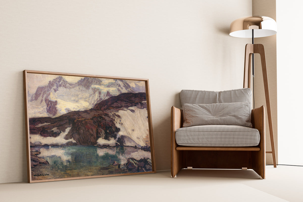 Framed art print of Breithorn (1925) by Hiroshi Yoshida, leaning against a wall beside an armchair and a floor lamp
