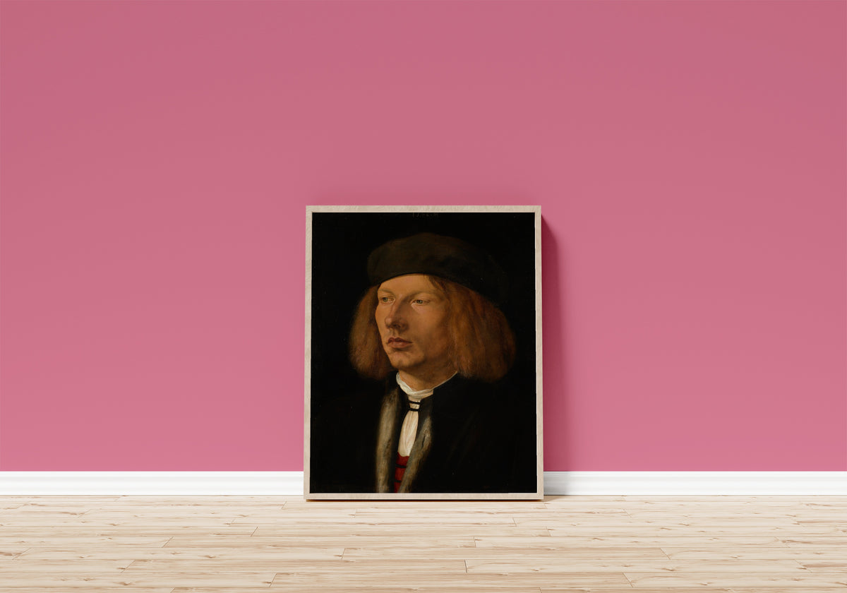 Framed art print of Burkhard of Speyer by Albrecht Dürer, in a light wood frame leaning on a pink wall above a wooden floor