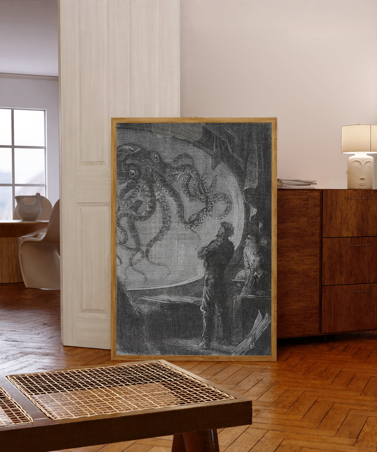 Framed art print of C'était un calmar de dimensions colossales (It… by Alphonse de Neuville, in a light wood frame leaning in a warm room with a parquet floor